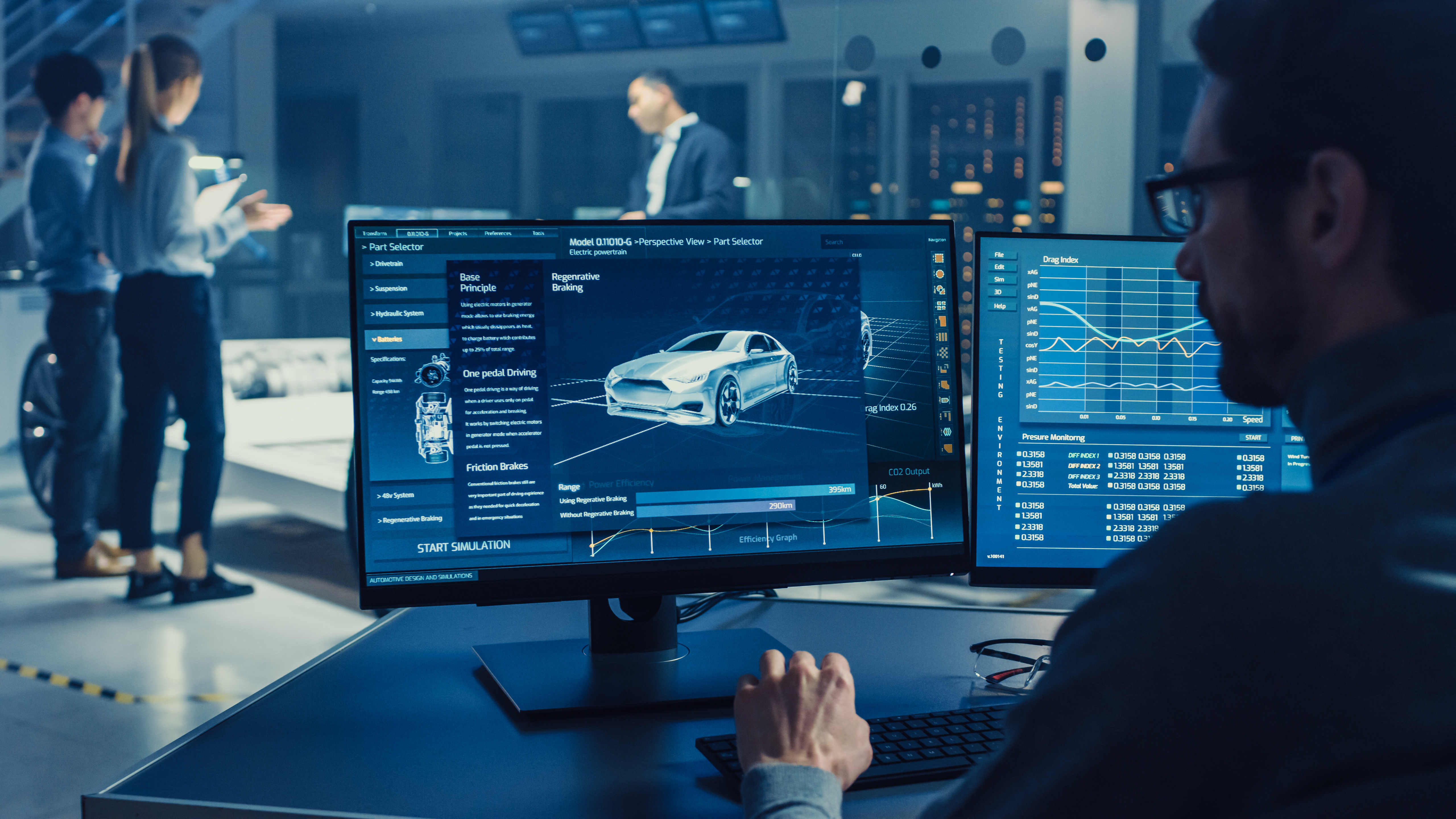 Test engineer sits at computer analyzing metrics and data.